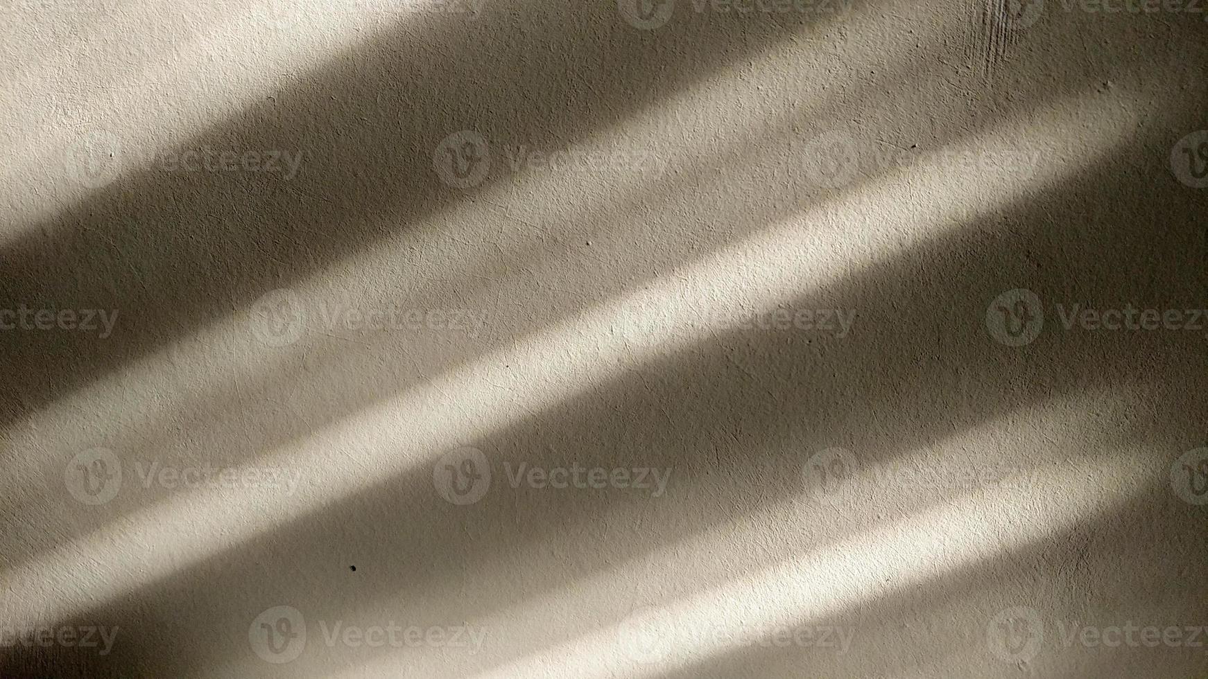 Shadow of bamboo curtains on the wall in the afternoon. Light and shadow concept. photo