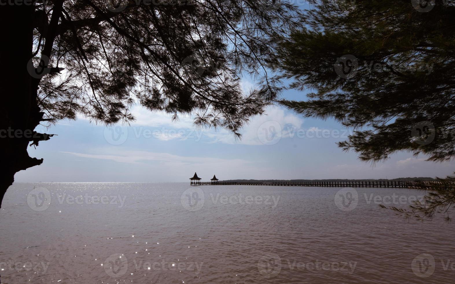 View on the beach with beautiful wooden pier photo