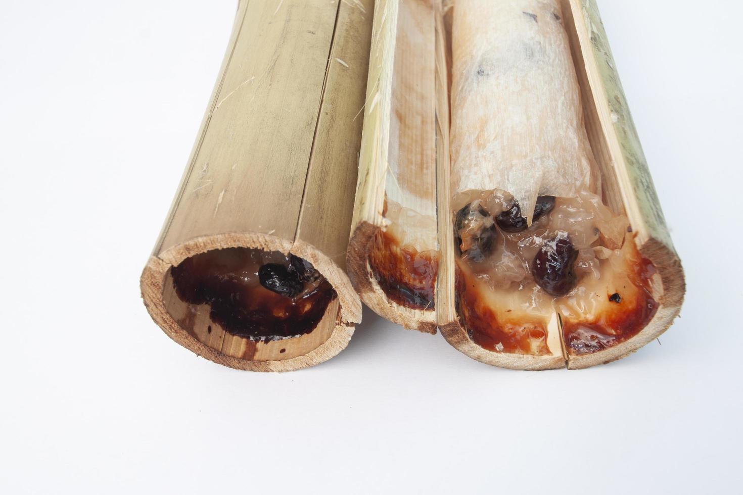 Thai dessert glutinous rice roasted in bamboo joints, Thailand call Kao Lam isolated on white background. photo