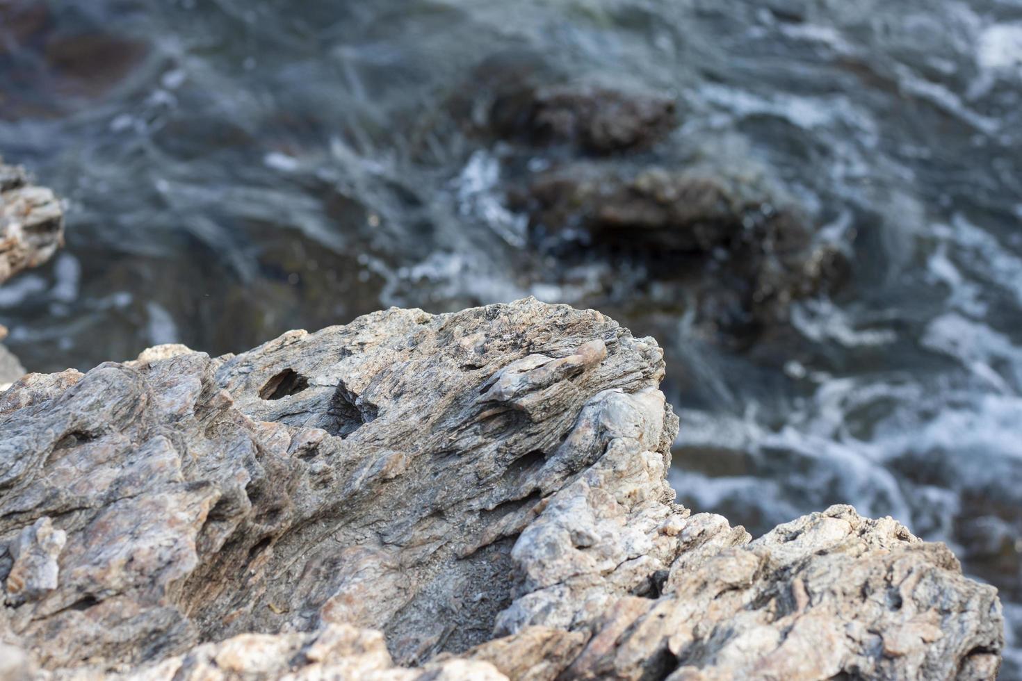 The rocks at the seashore and the waves that washed into the coast. photo