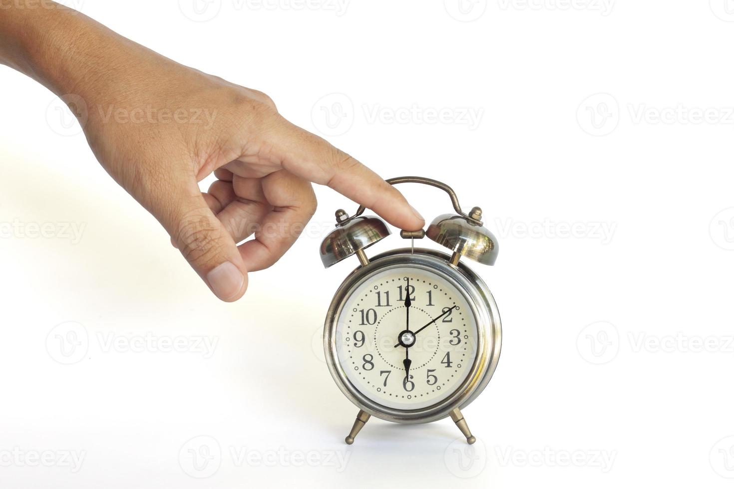 Hand of men turning off the alarm clock isolated on white background included clipping path. photo