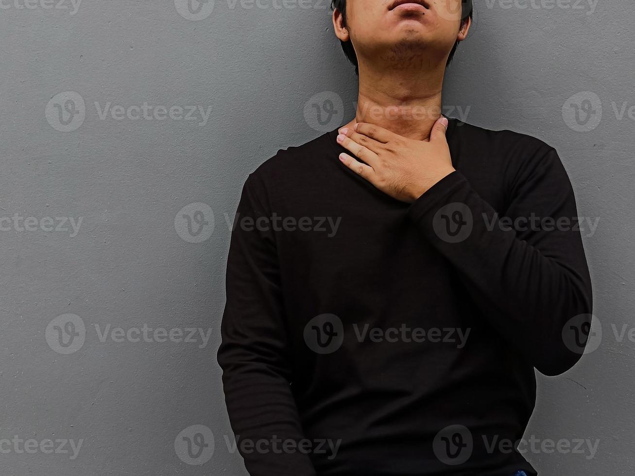 Asian young men have a sore throat. Medical and healthcare concept. photo