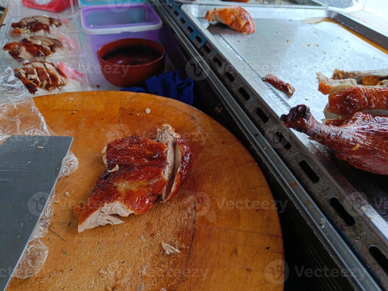 Roast duck on a wooden cutting board to prepare for slicing. Duck rice shop photo