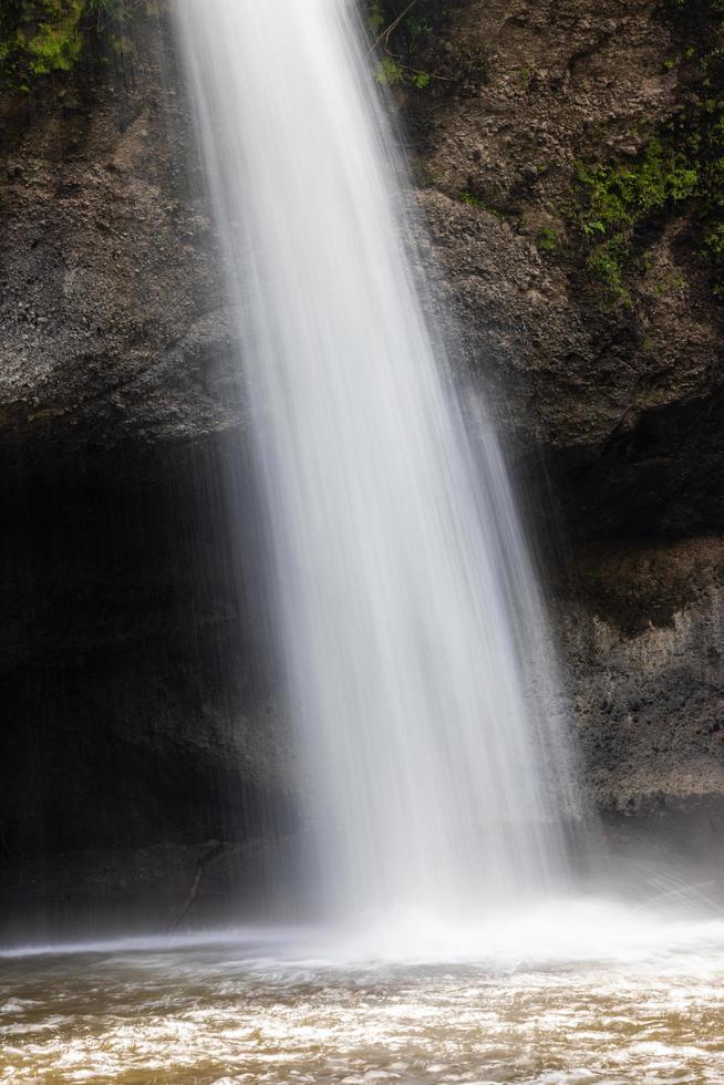A natural waterfall in a big forest in the midst of beautiful nature. photo
