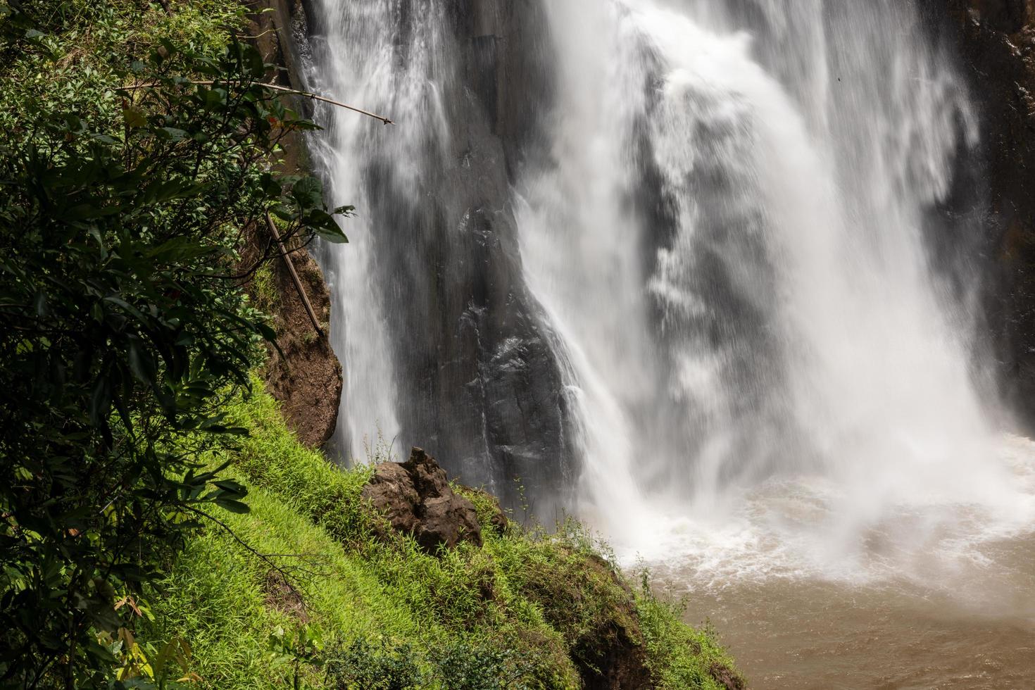 A natural waterfall in a big forest in the midst of beautiful nature. photo