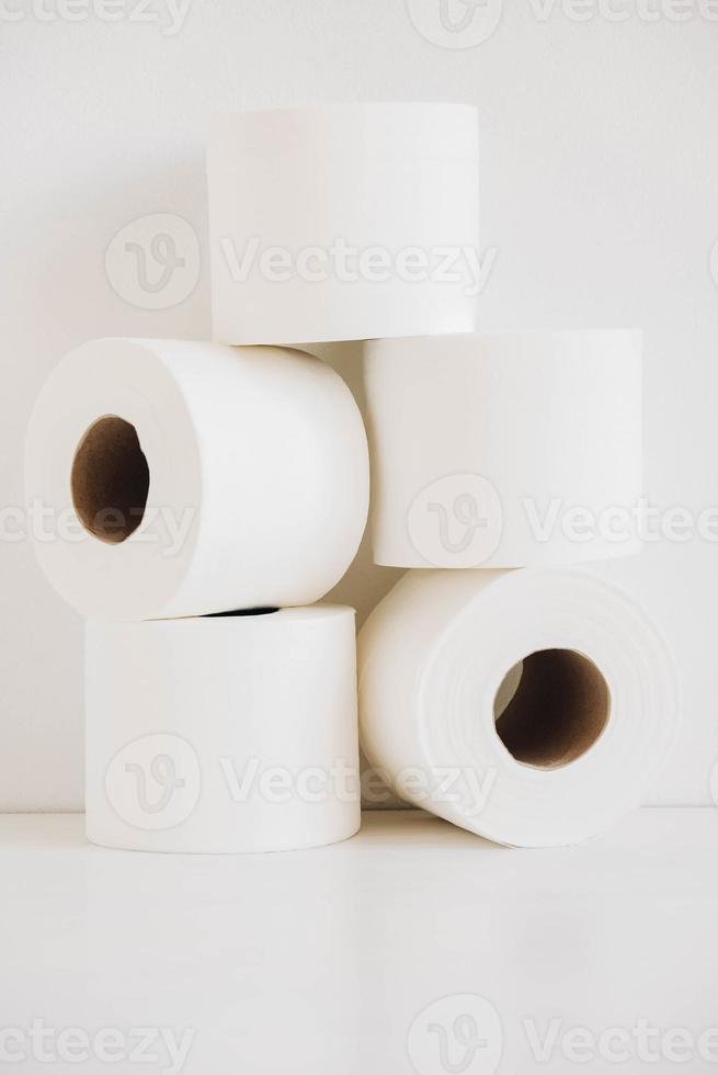 Rolls of white toilet paper on a white background photo