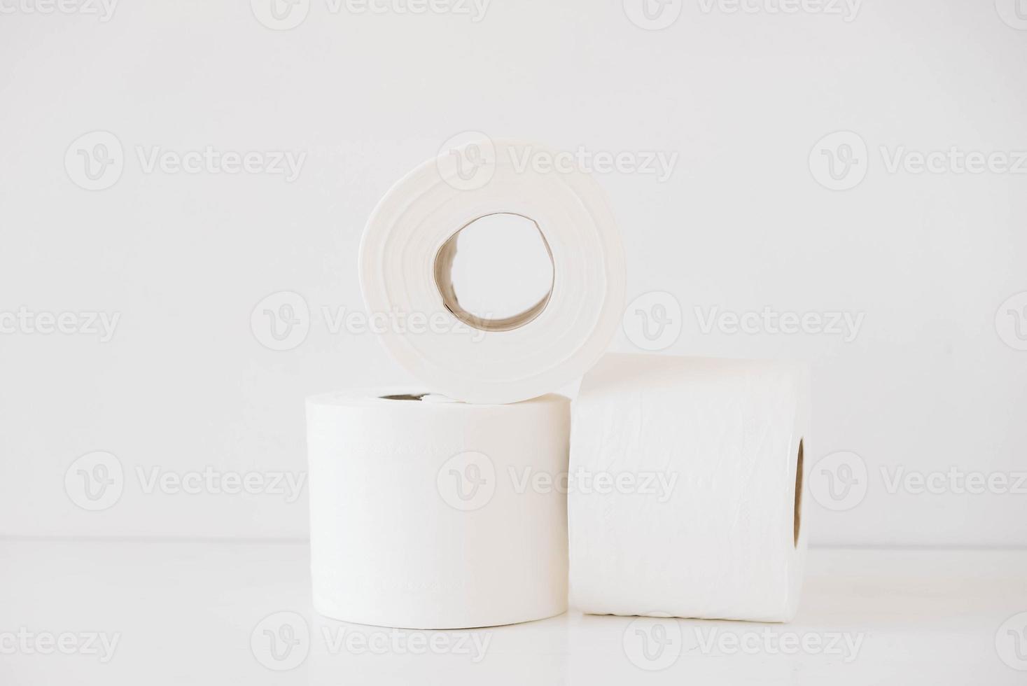Rolls of white toilet paper on a white background photo