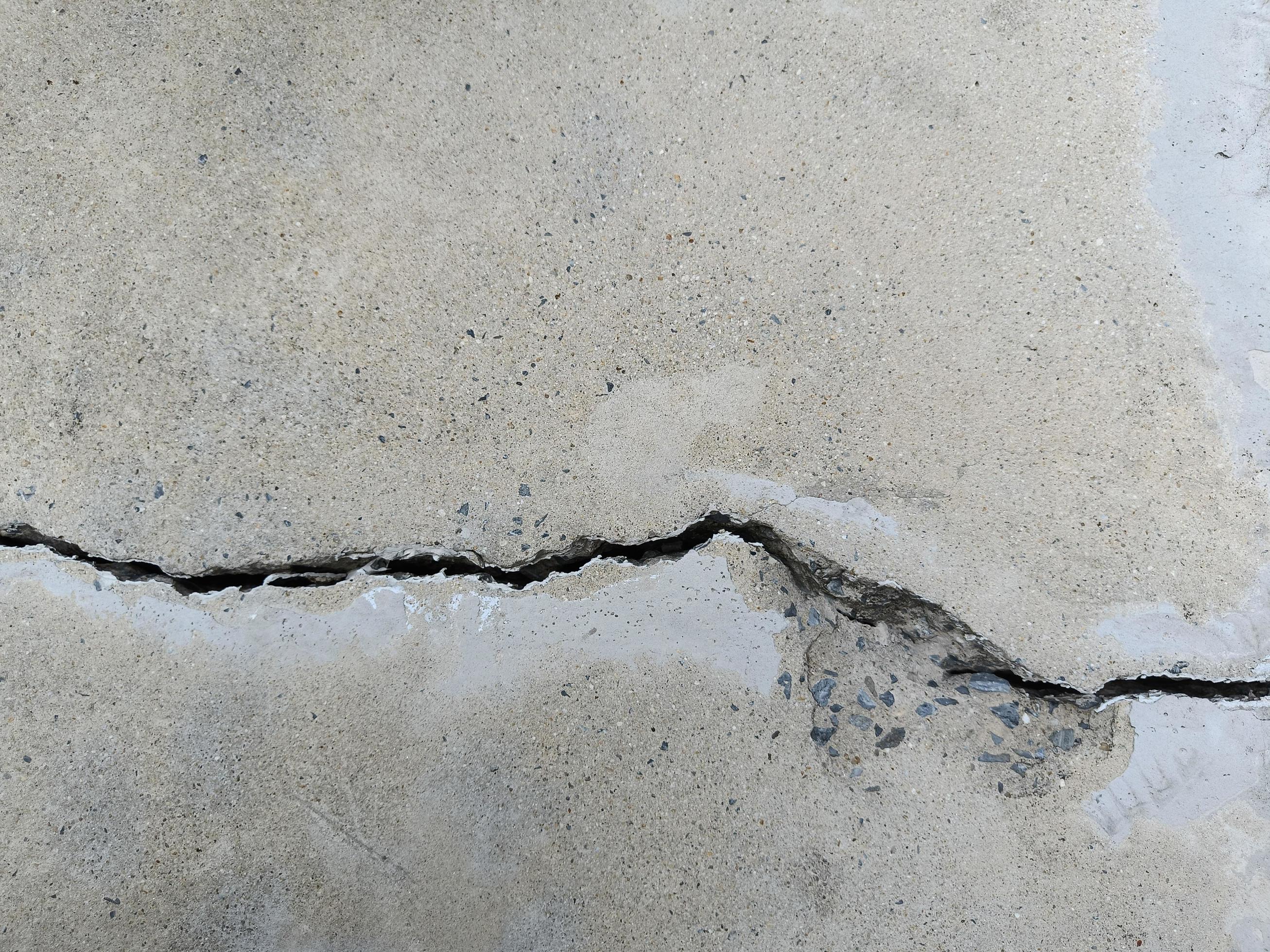 Cracked concrete building or floor cement wall broken at the outside