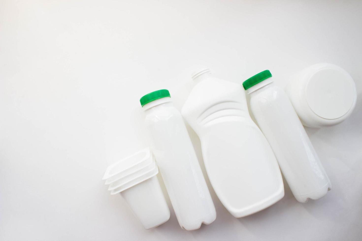 White plastic bottles on white background with place for your design. Top view photo