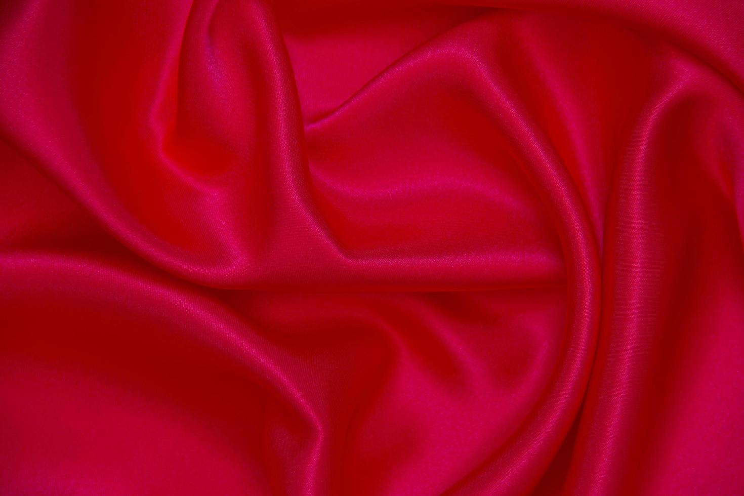Red cloth waves background texture. photo