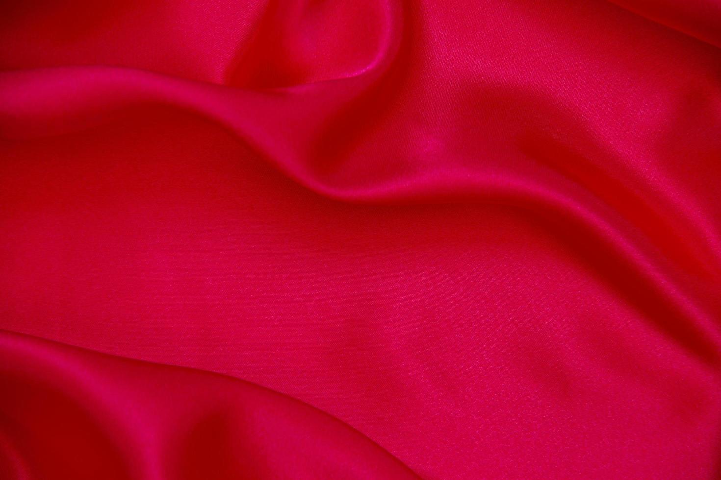 Red cloth waves background texture. photo
