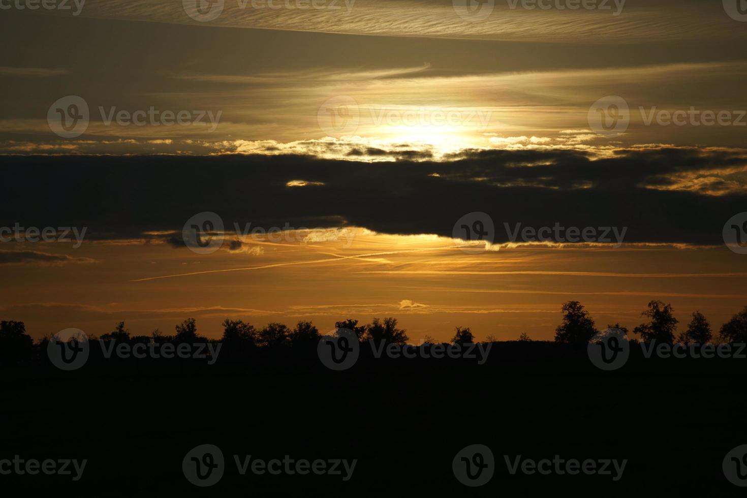 Setting sun on the outskirts of Berlin. The sky seems to burn photo