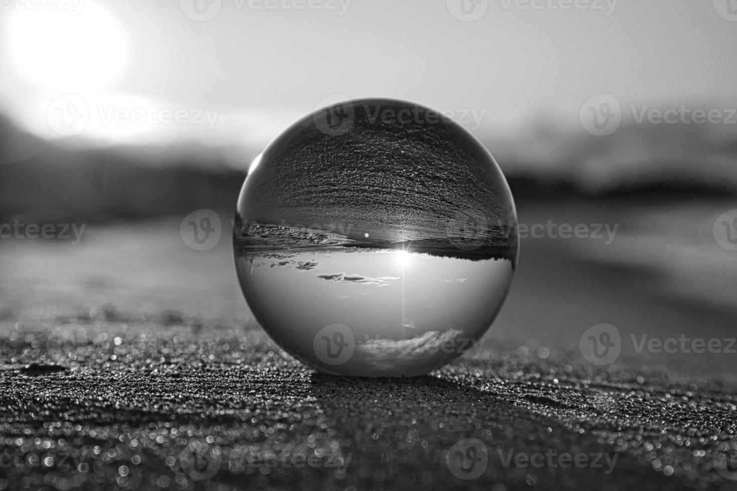 Glass globe on the beach of the Baltic Sea in Zingst in which the landscape is depicted photo