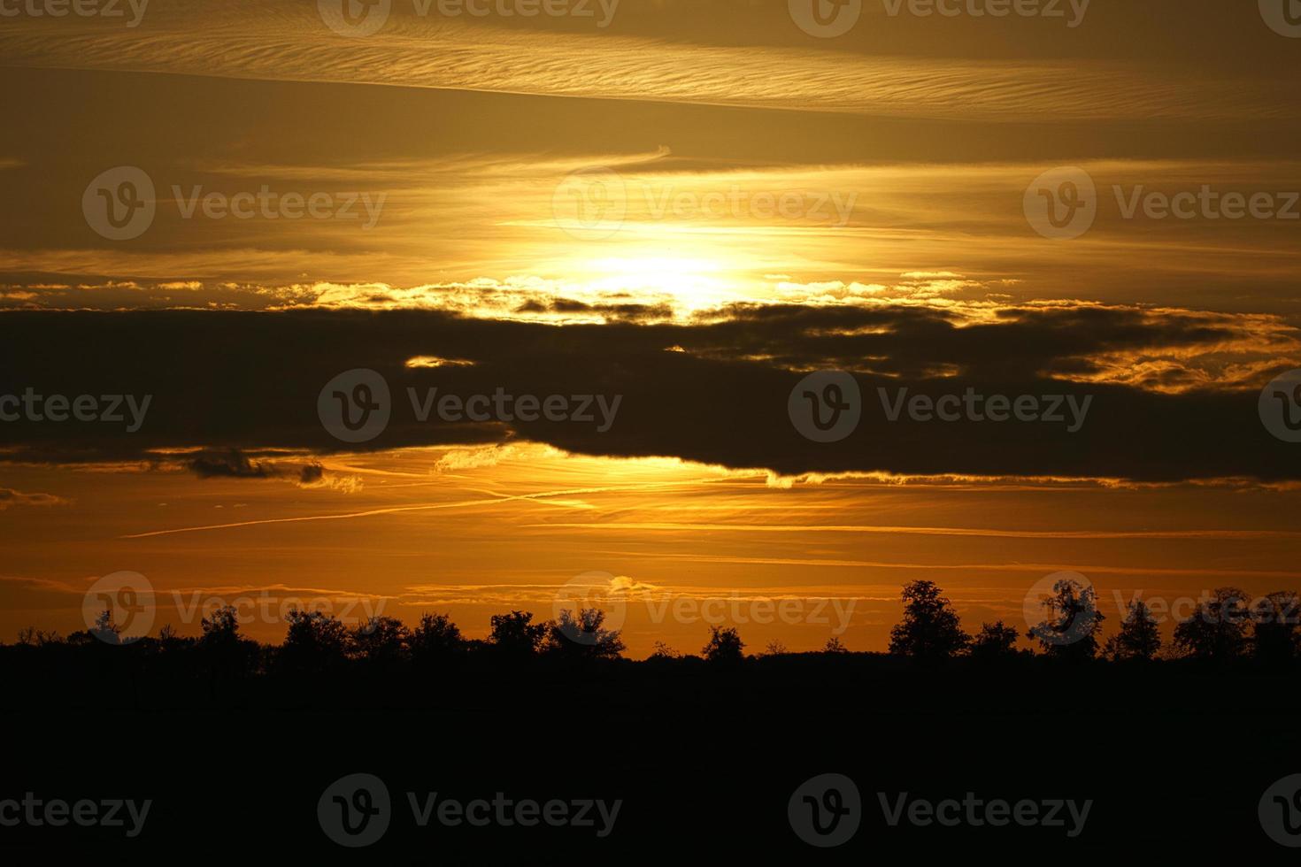 Setting sun on the outskirts of Berlin. The sky seems to burn. photo