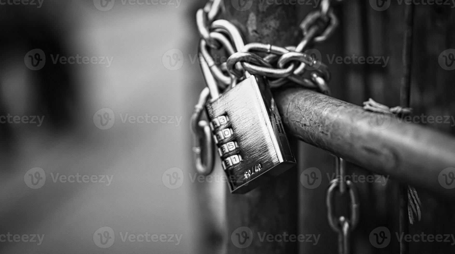 Padlock in black white on a chain. Locked and locked. mysterious and safe. photo