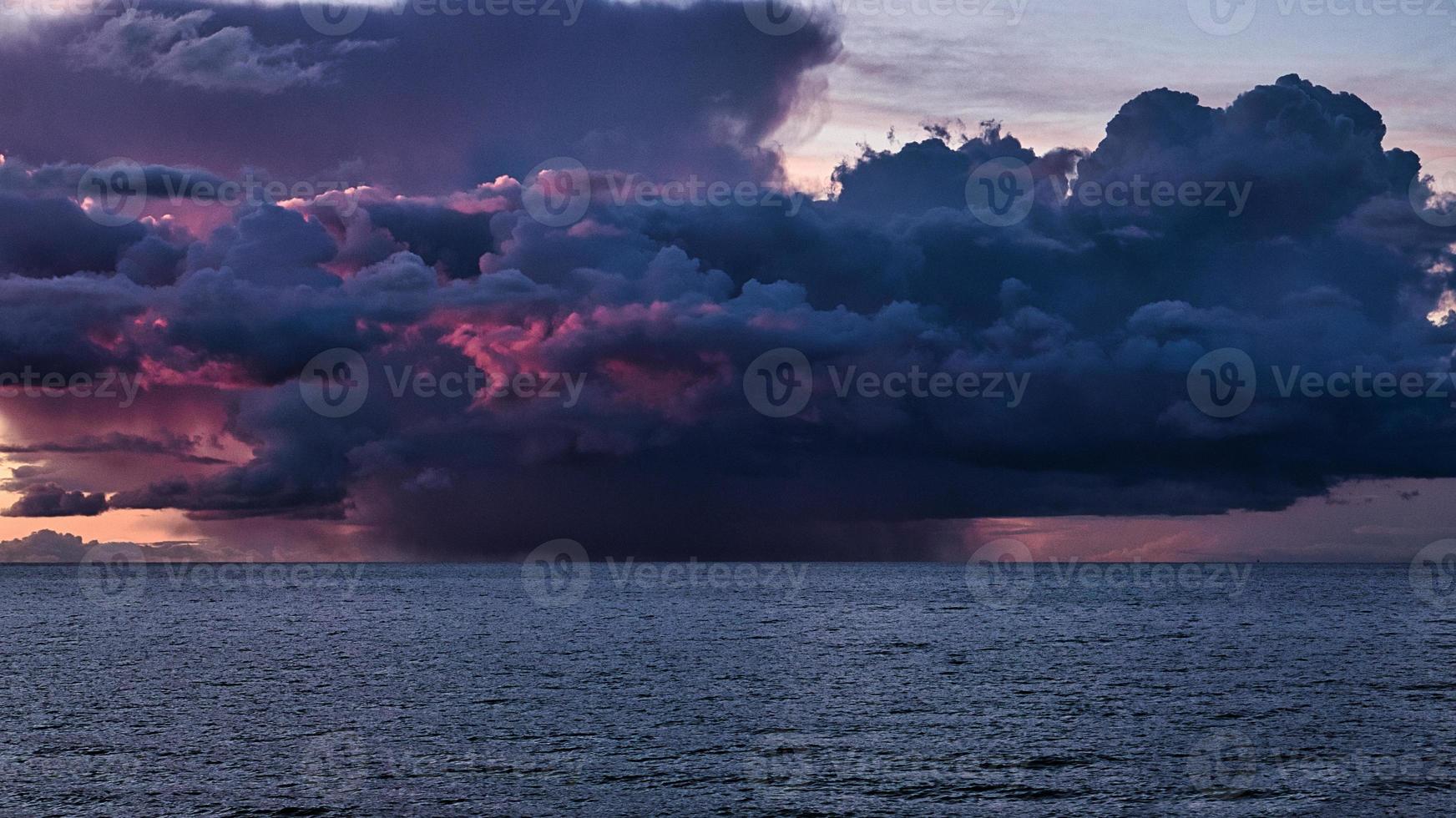 dramatic sunset with rain clouds. color spectacle on the Baltic Sea in Zingst photo