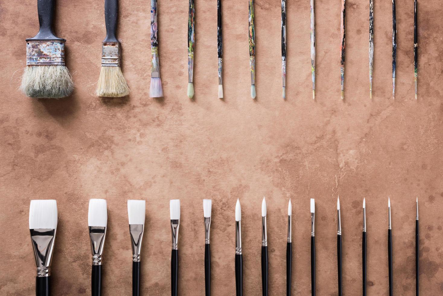 Paint brush on old parchment paper vintage aged or texture background photo