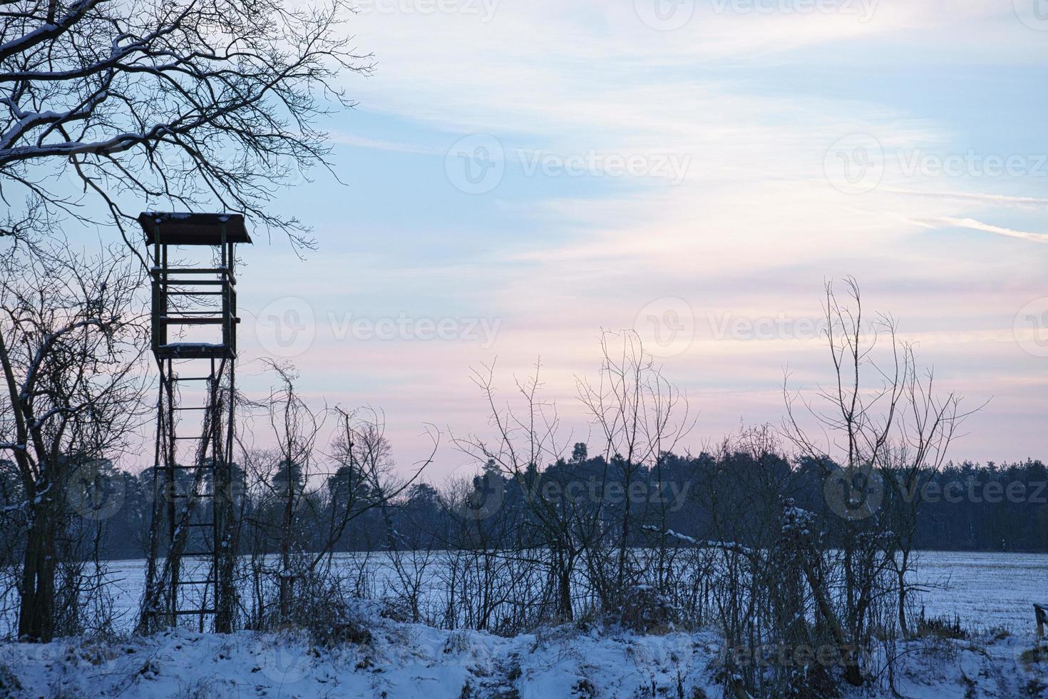 High stand for hunting in a winter snowy landscape. photo