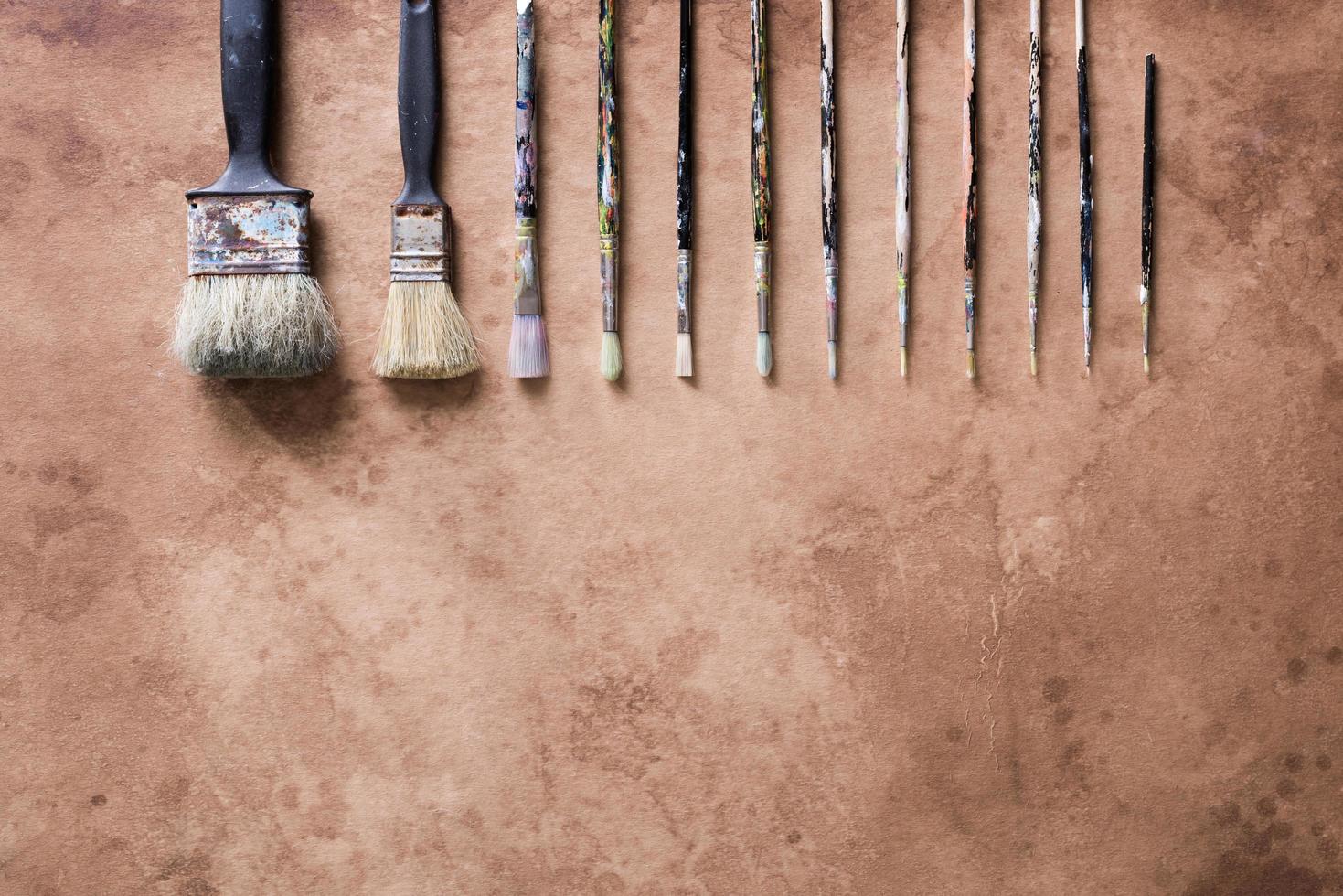 Paint brush on old parchment paper vintage aged or texture background photo