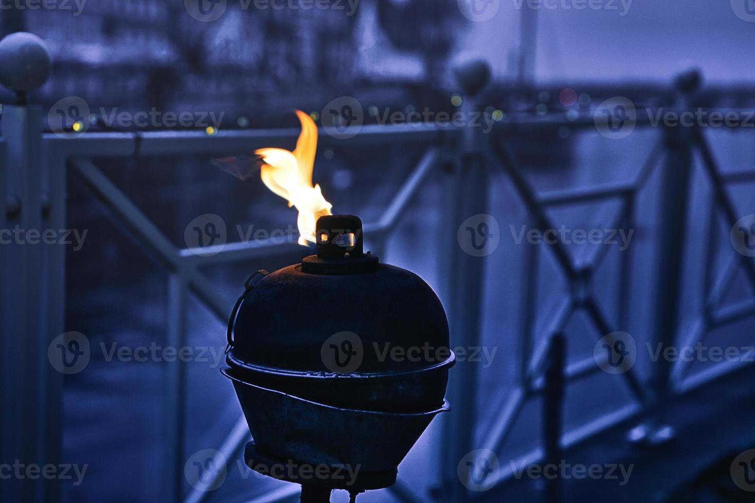 Burning oil lamp by the water in relaxed mood in Blavand photo