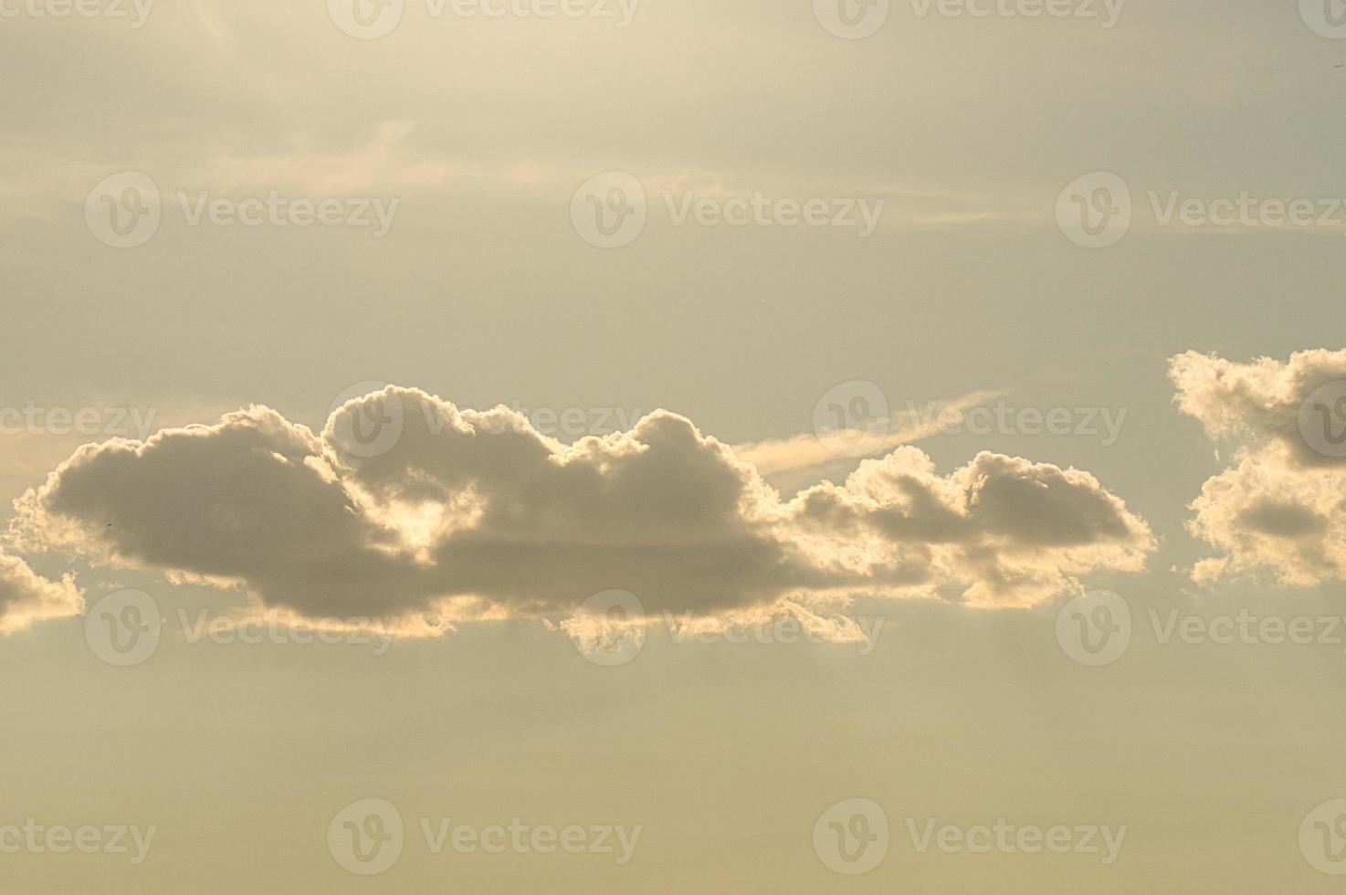 Clouds illuminated by the sun in the sky as background photo