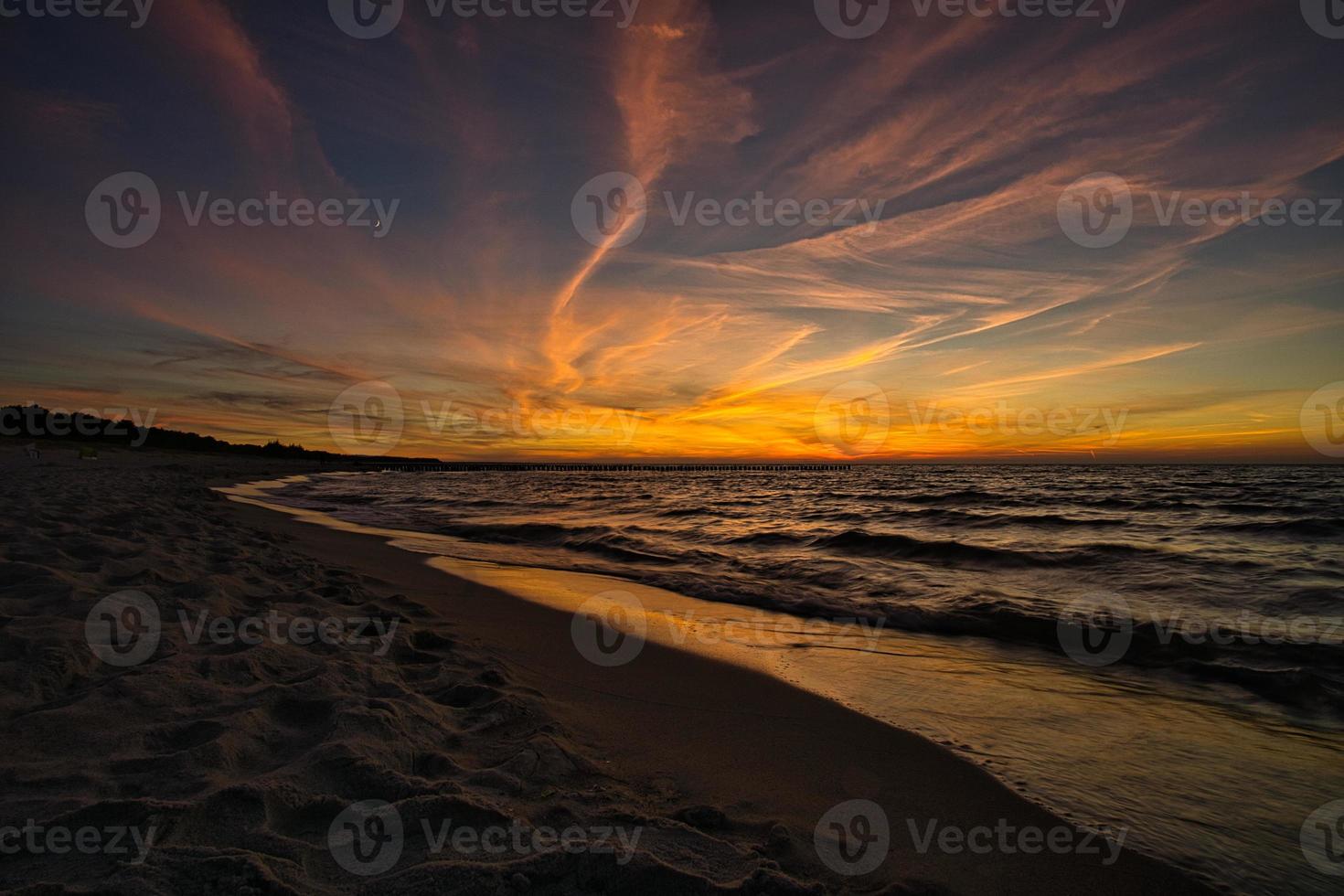 sunset on the beach of zingst at the baltic sea photo