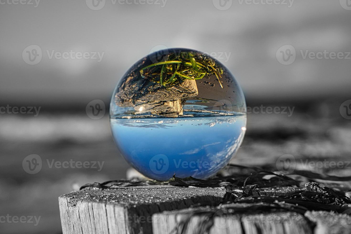 glass globe on the beach of the baltic sea. photo