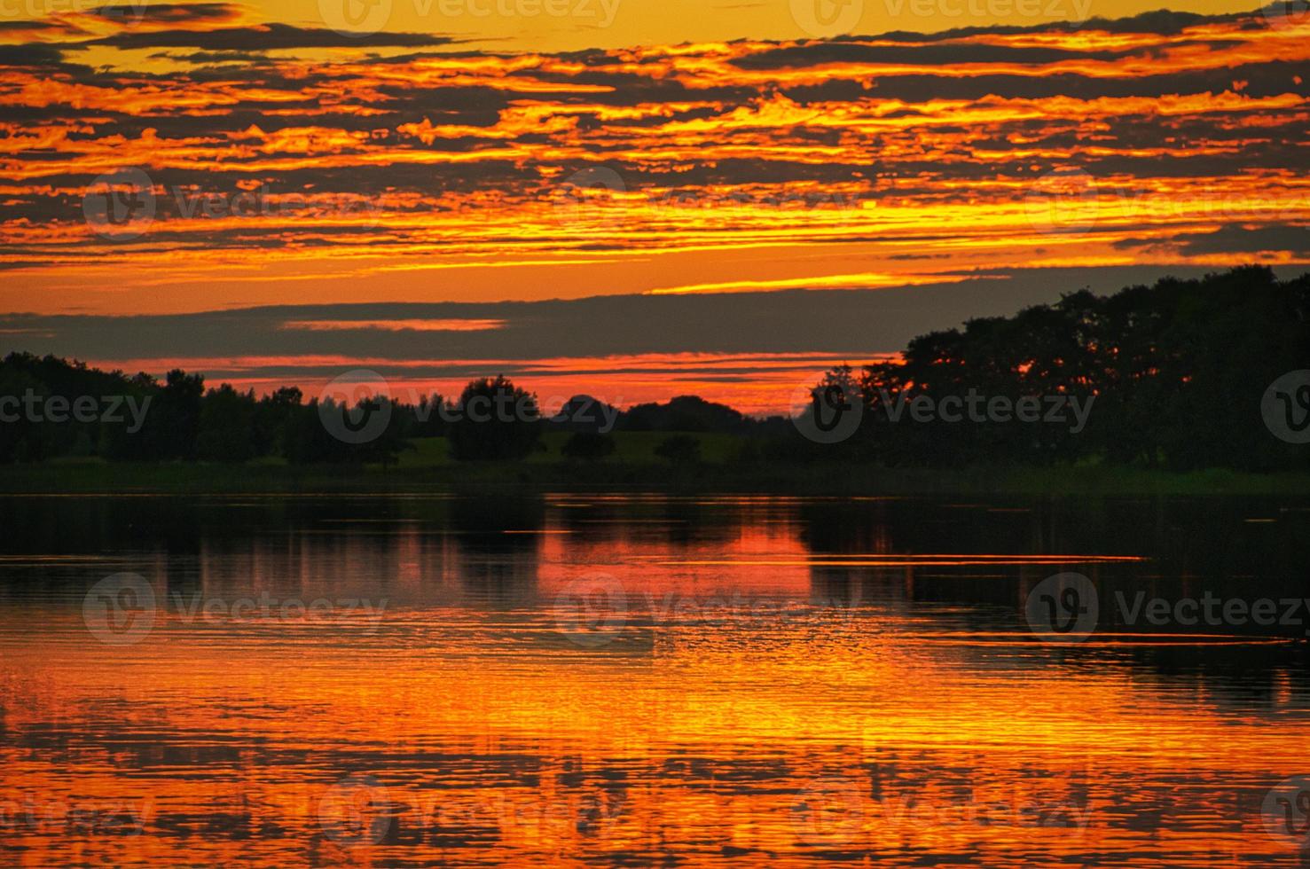 reflection of the sky in the water. gold, yellow and pink colors of the sky are reflected in the lake. photo