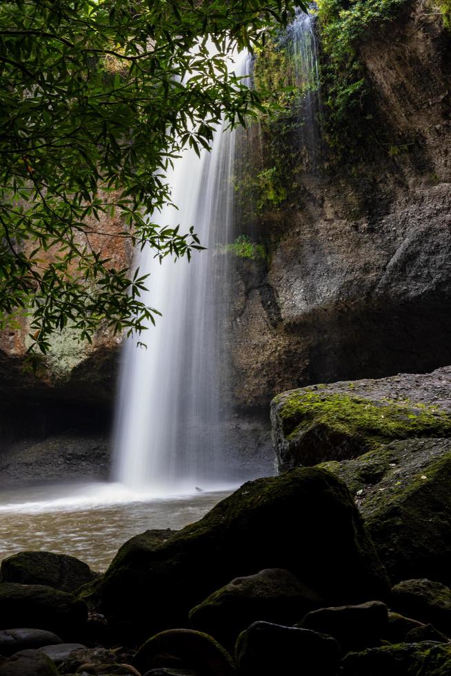 A natural waterfall in a big forest in the midst of beautiful nature. photo