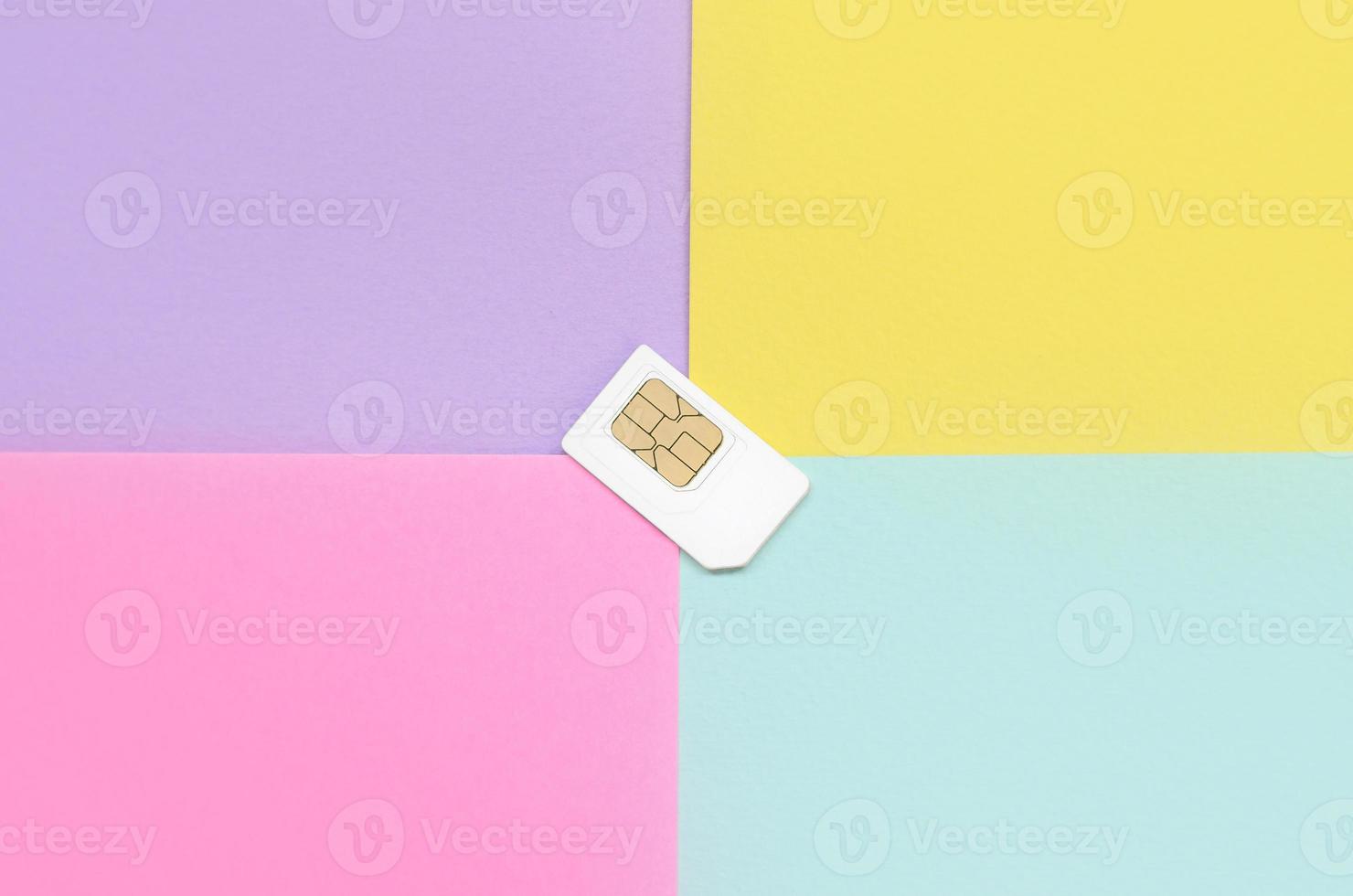 Subscriber identity module. White SIM card on pastel background photo