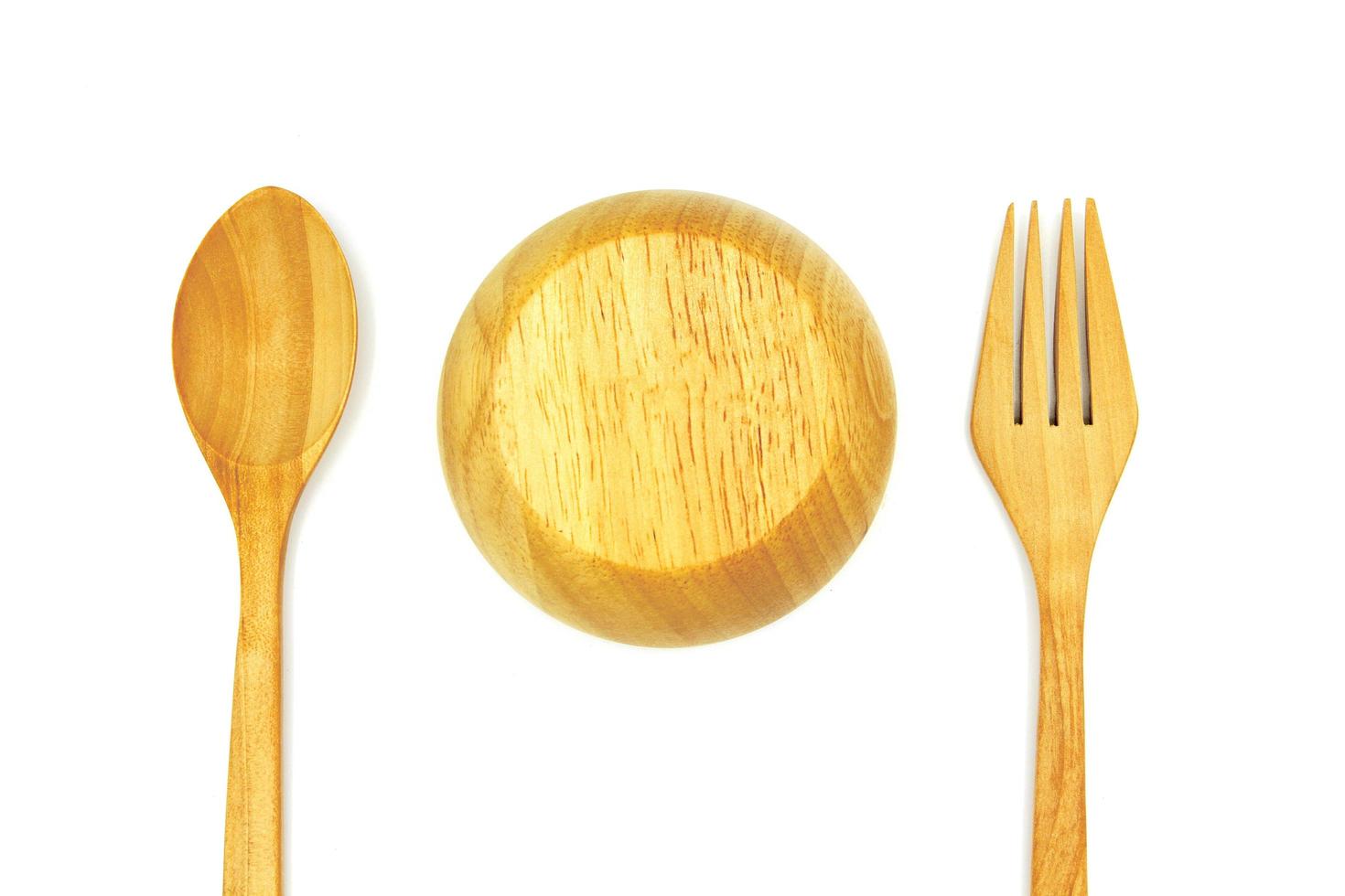 Close up and top view wooden spoon, bowl up and fork isolated on white background. Studio light concept photo