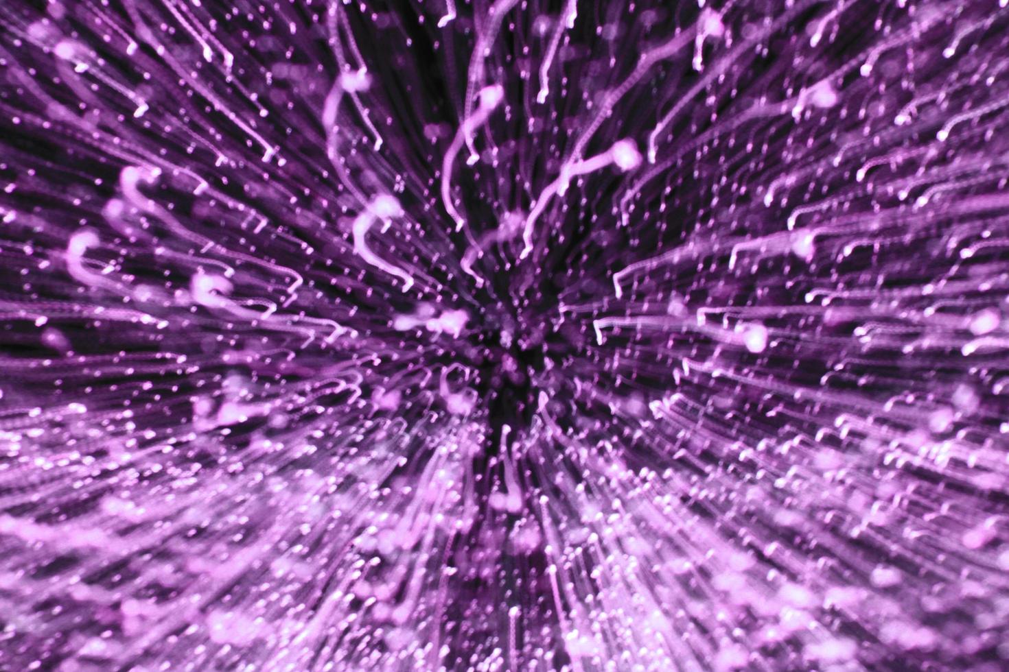 Blurred purple or violet light background. Abstract art of lighting blur wallpaper at festival. Defocus, zooming and out of focus technique. photo
