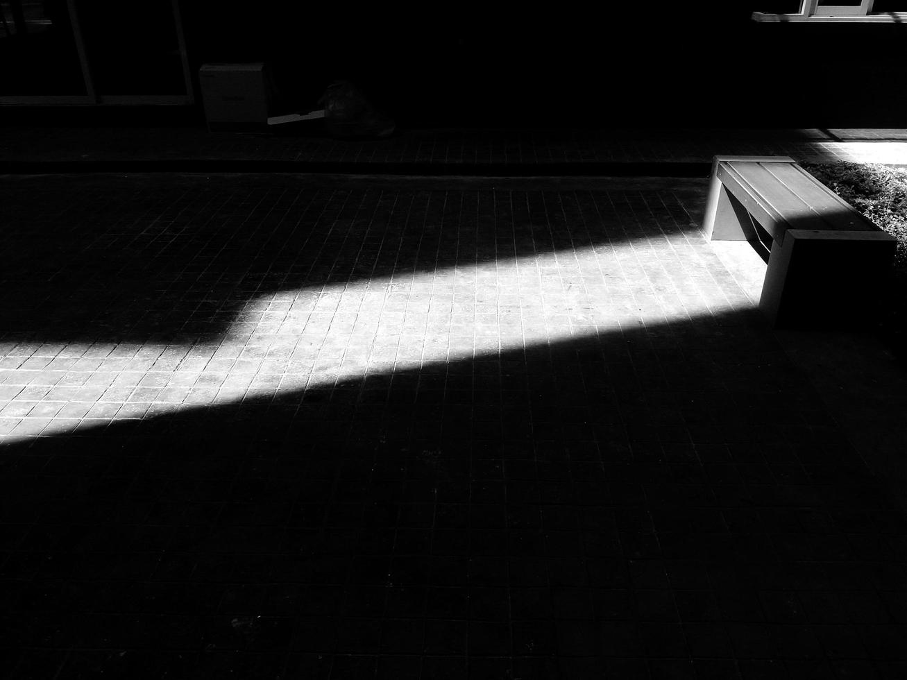 Gray or Grey bench with light and shadow in back and white tone. Art of object with sunlight. photo