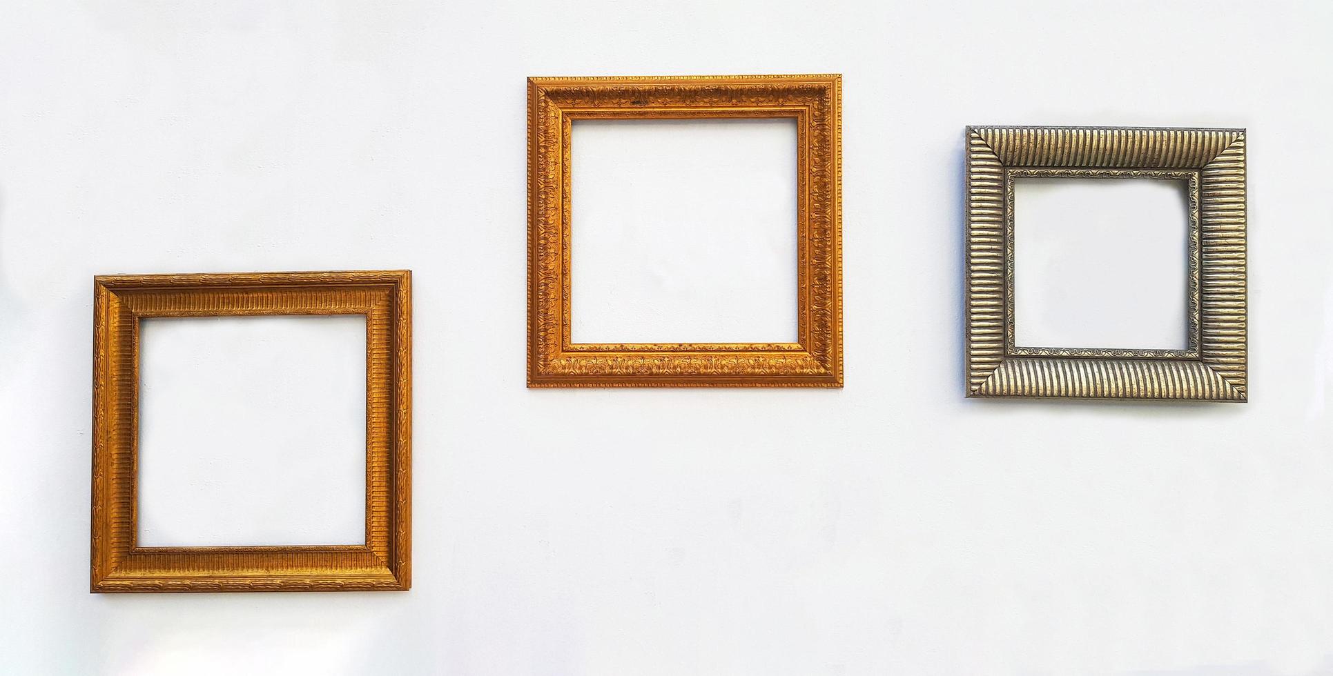 Many empty colorful picture frame mock up on white concrete wall with copy space for add or fill text. Framework on background. Free space photo