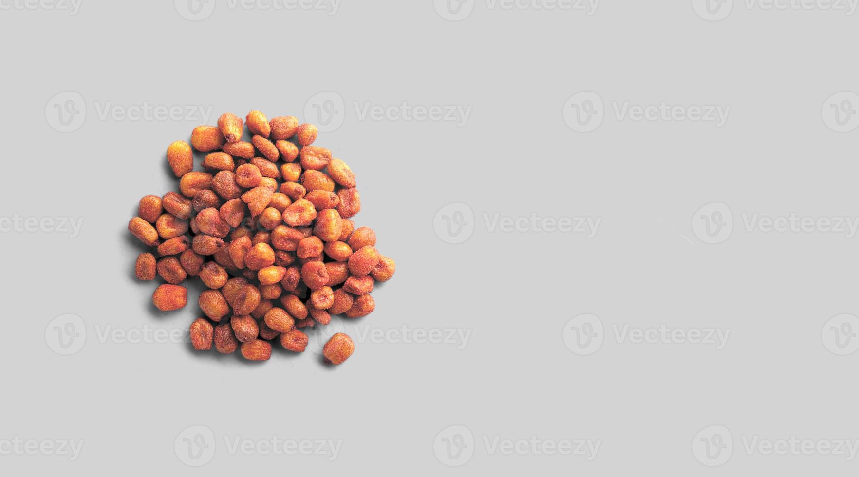 Fried salted Mexican corn on the grey background. close up view. photo