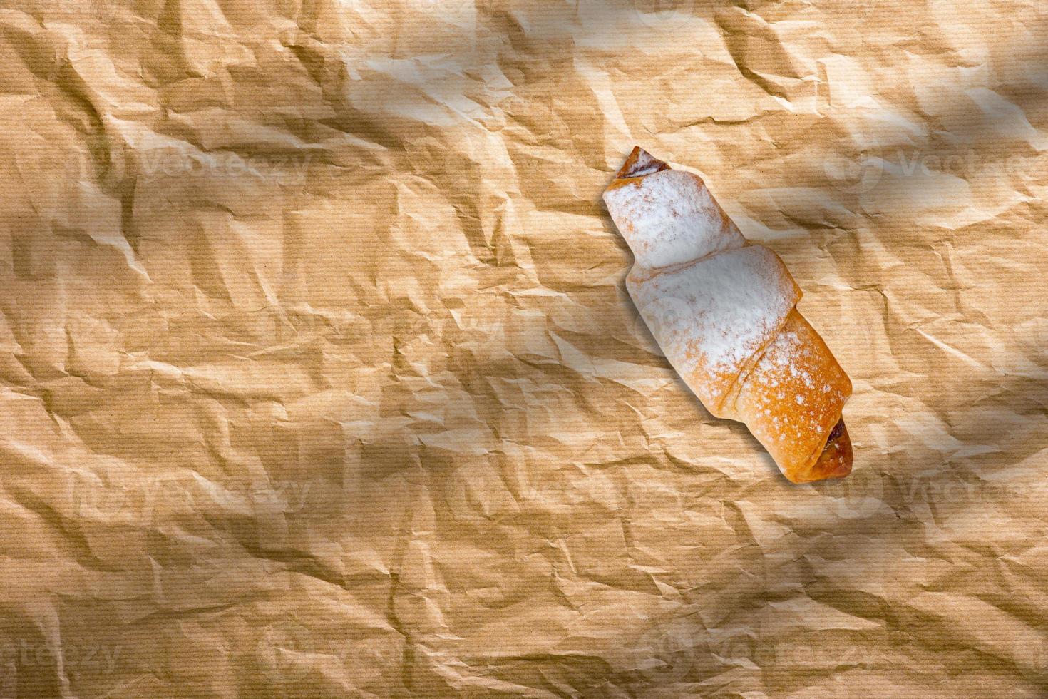 Fresh homemade croissants on baking paper. French bakery concept photo