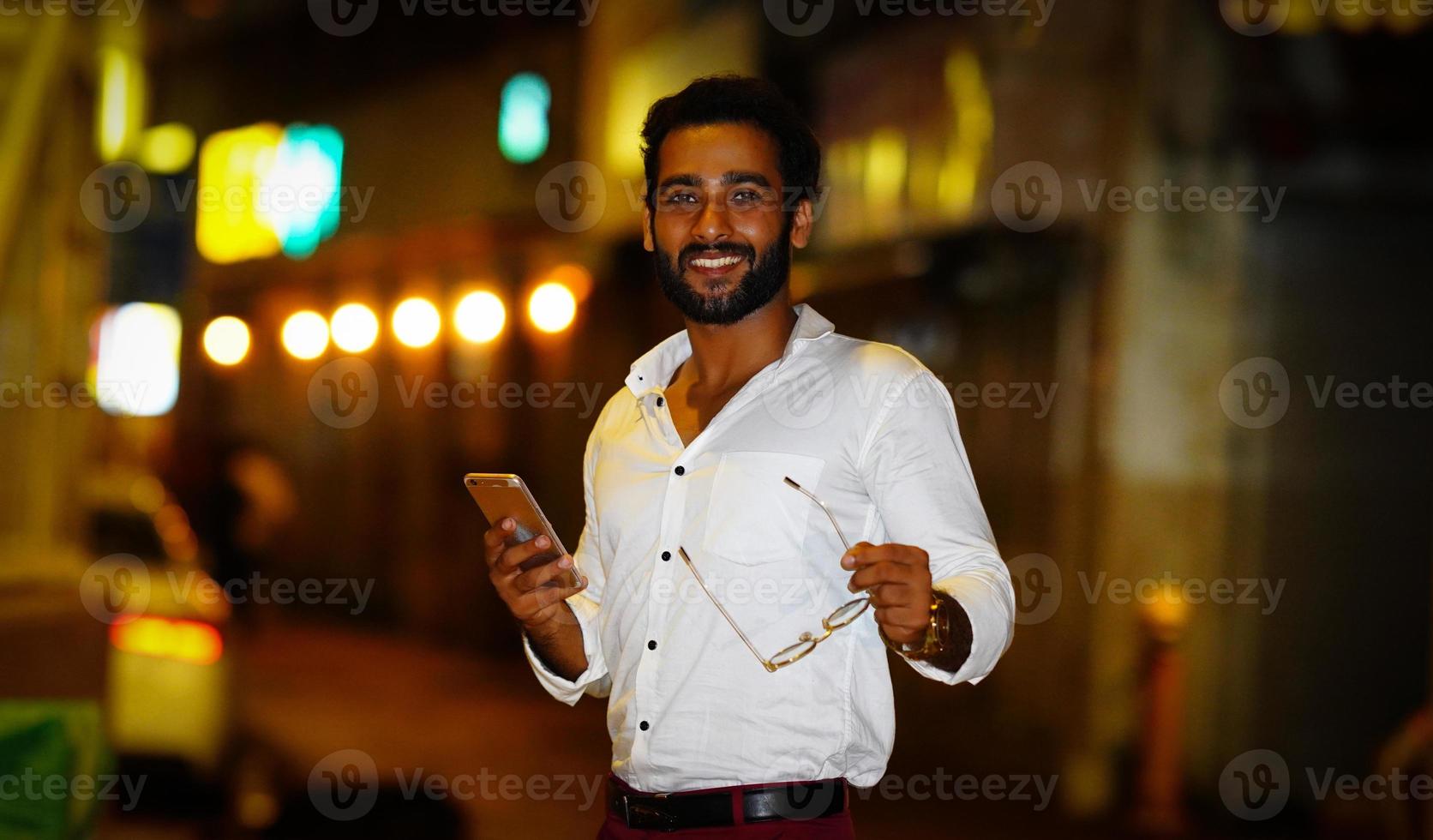 indian boy using mobile with excitement outdoor image photo