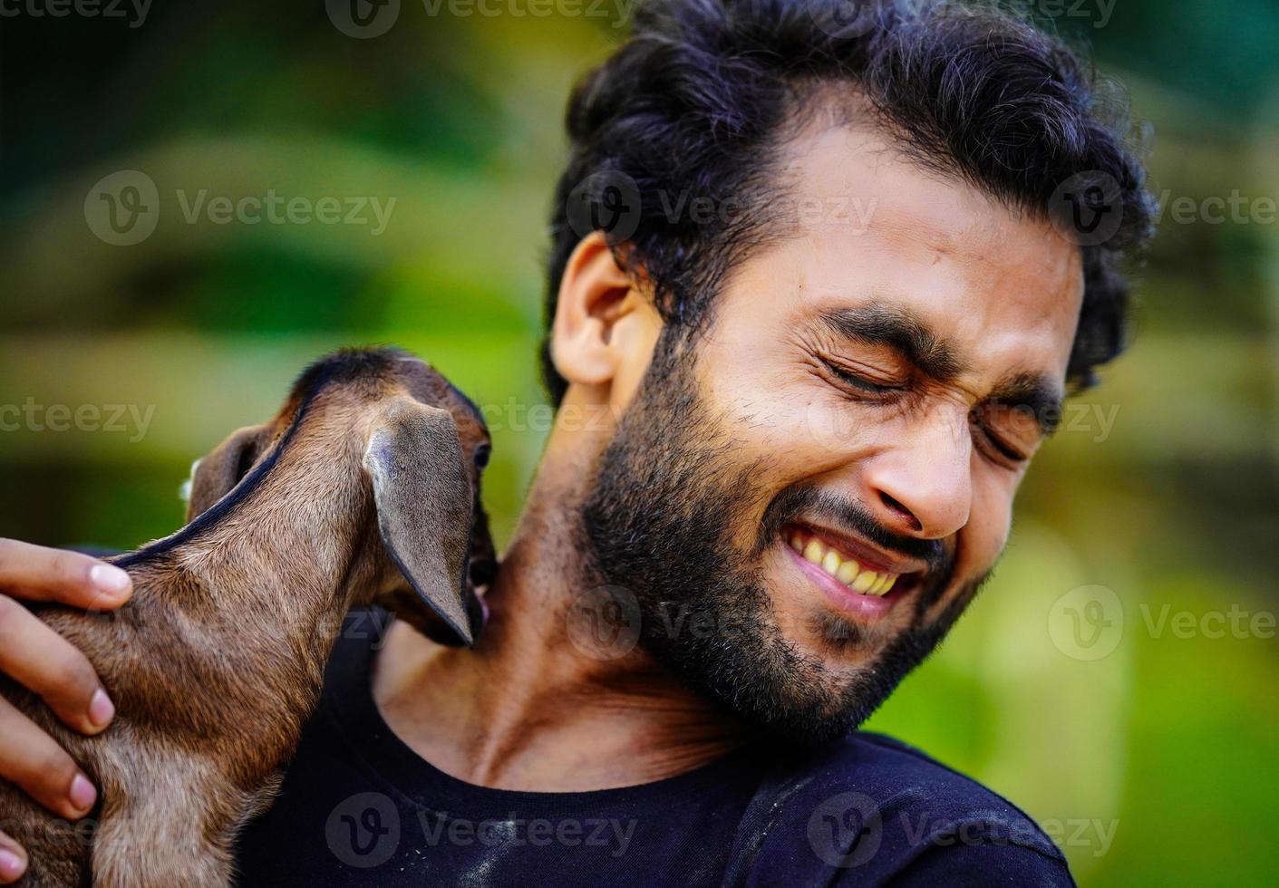 boy with cute baby goat pet animal photo