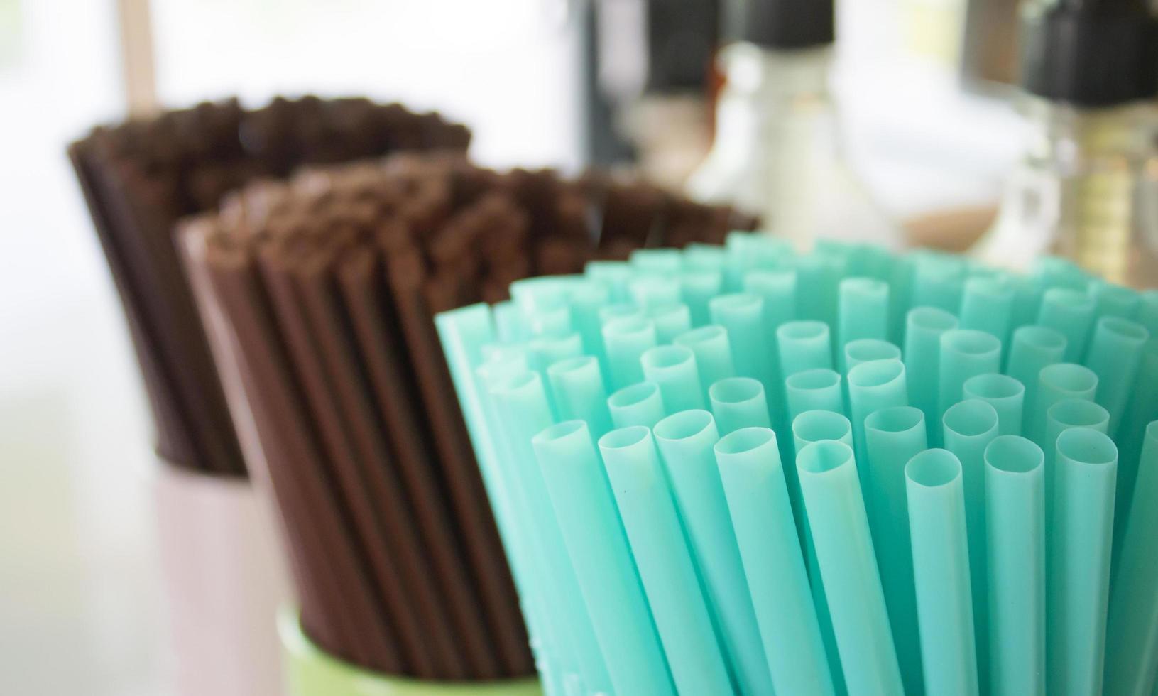 Drinks straws in container in cafe photo