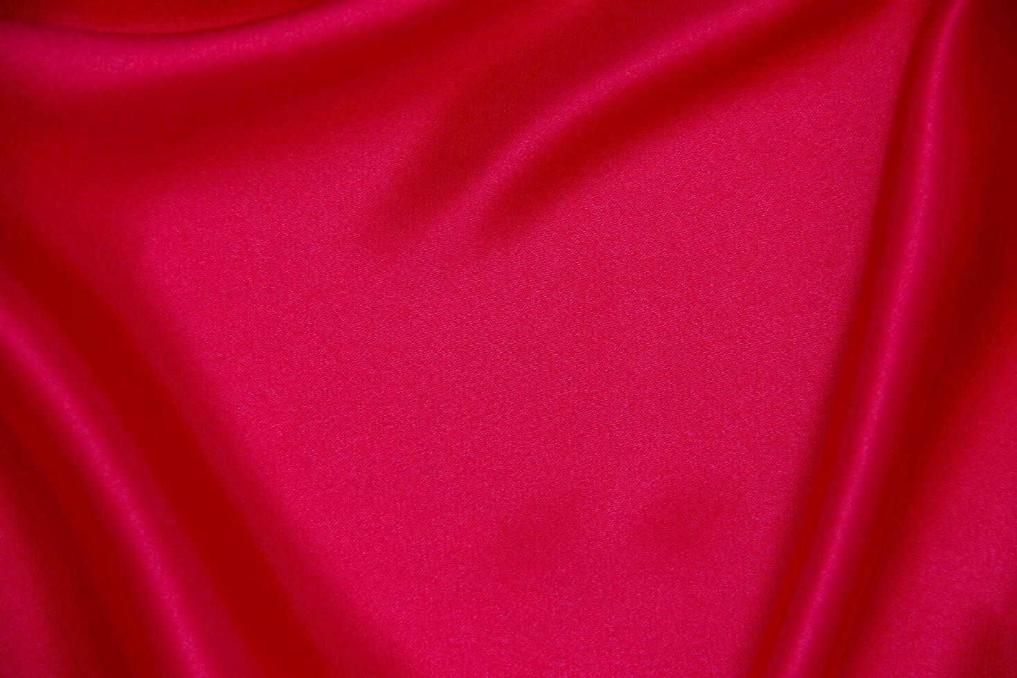 Red cloth waves background texture. photo