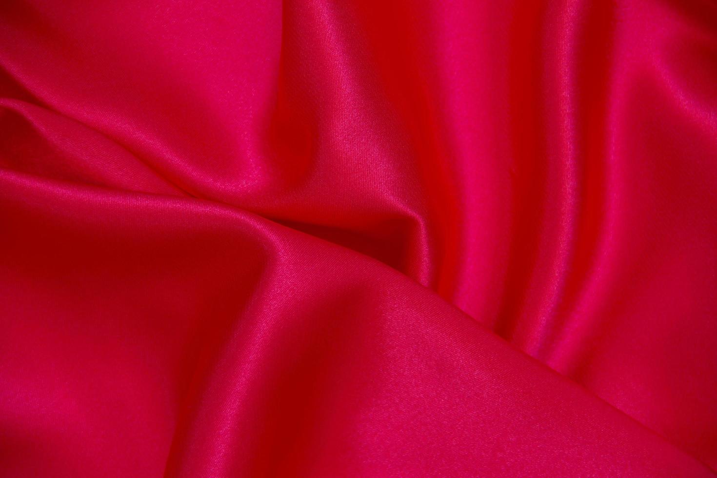 Red cloth waves background texture. photo