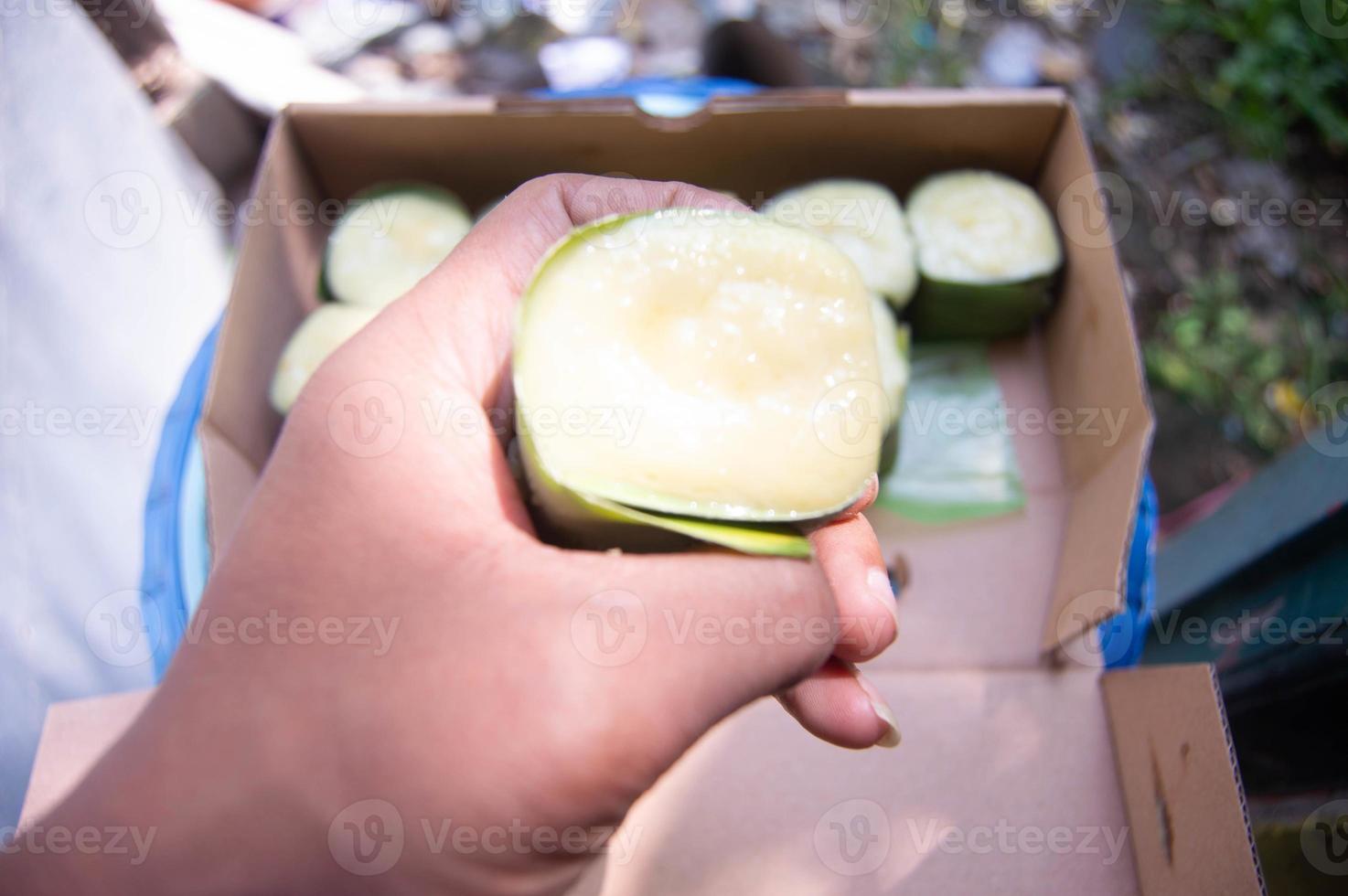 sweet snacks from sticky rice with durian topping that someone is holding. Indonesian traditional food. photo