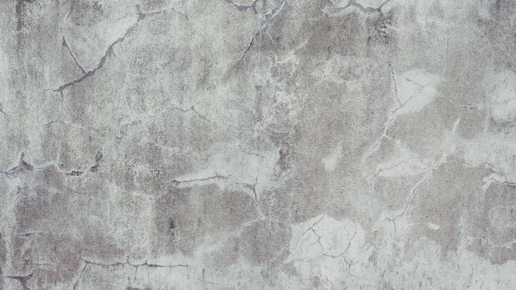 The old cement wall was weathered, the surface was scratched, the surface was scratched and damaged. For a mysterious retro-conservative background. photo