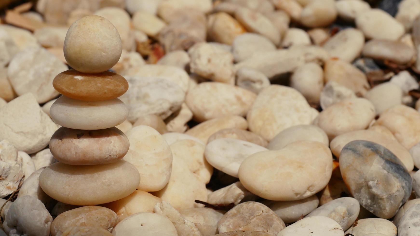 The Balance Stones are stacked as pyramids in a soft natural bokeh background, representing the calm philosophical concept of Jainism's wellness. photo