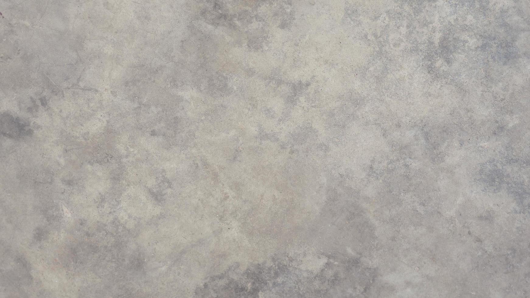 The old cement wall was weathered, the surface was scratched, the surface was scratched and damaged. For a mysterious retro-conservative background. photo