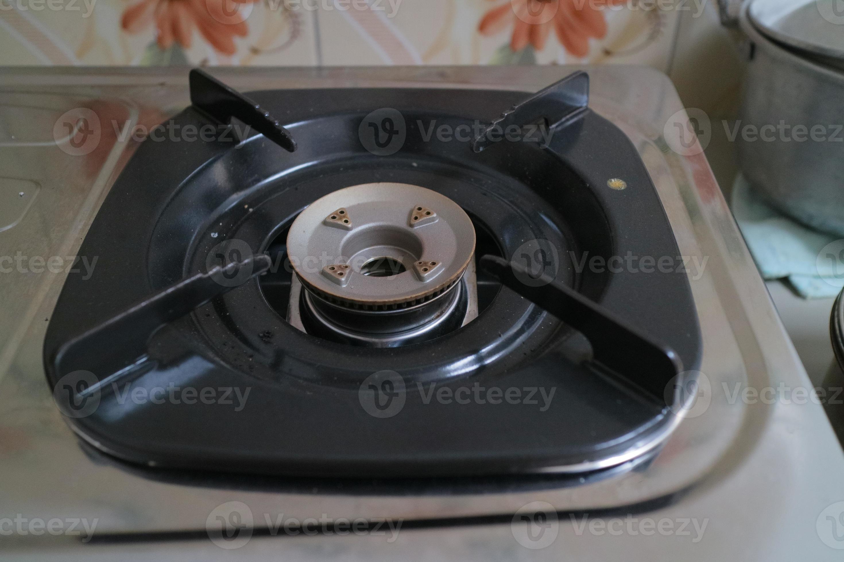 black square placemats on the gas stove 9748291 Stock Photo at Vecteezy