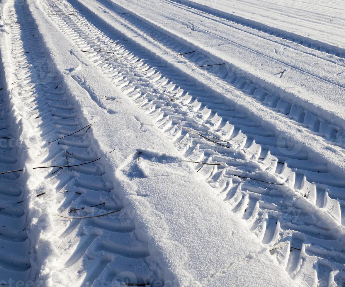 Snow drifts in winter road photo