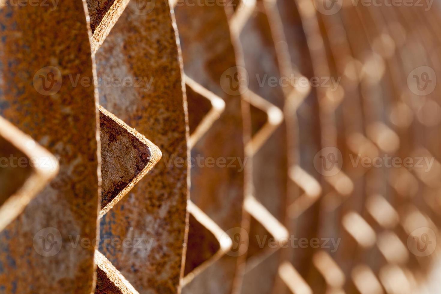 rusty metal element of the agricultural plow close up photo