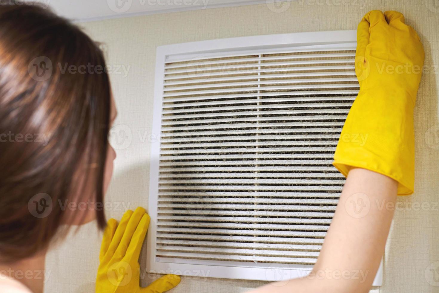 Holding ventilation grill of HVAC for cleaning or replacing. photo