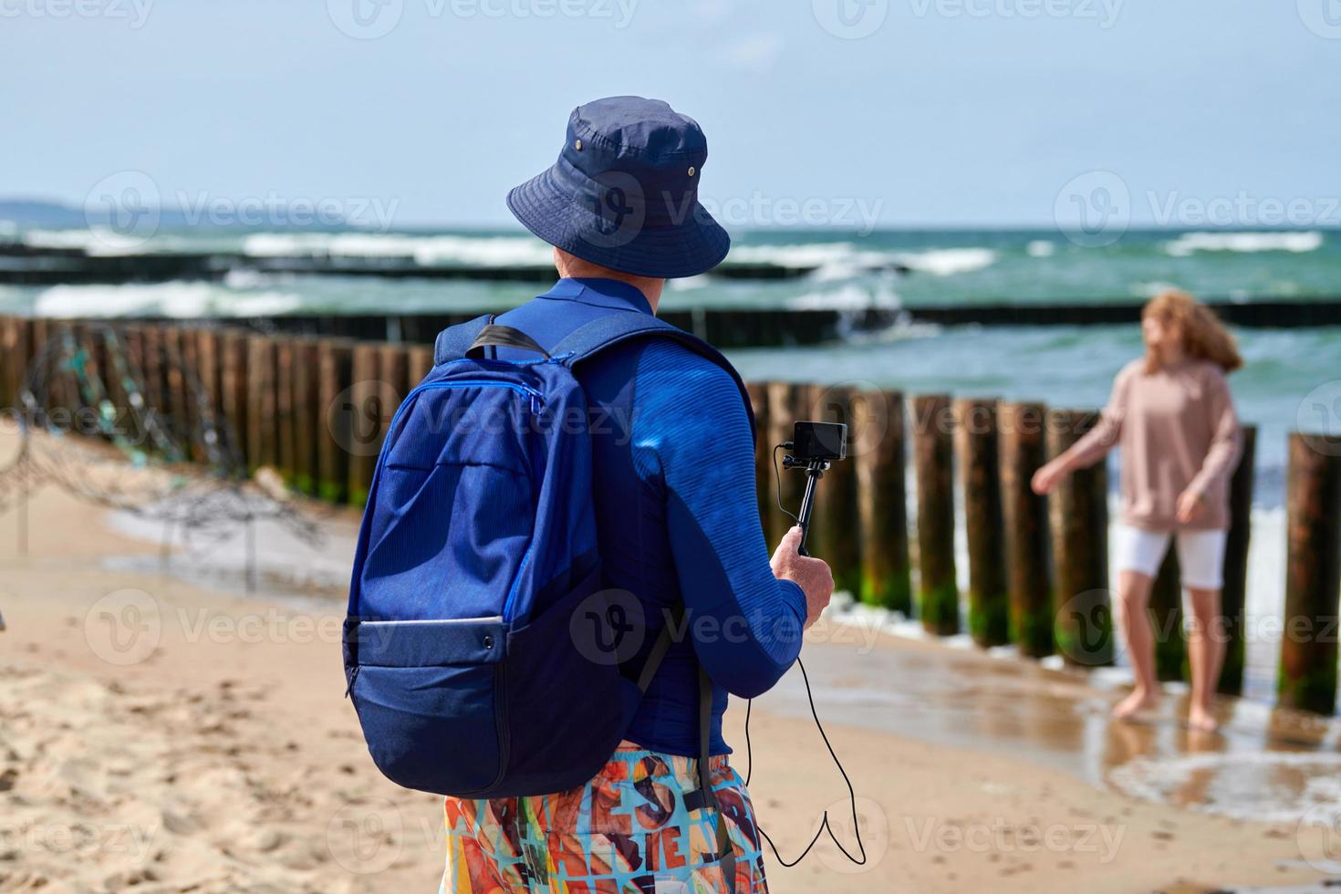 Male tourist recording video on action video camera, digital camera, blogger filming video blog photo